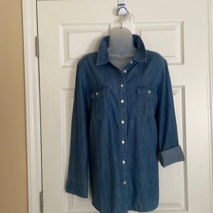 Denim shirt.  Vertically striated, curved hem.  Hits at hip.